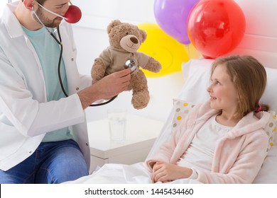 Young Volunteer Playing With A Sick Child