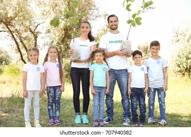 Young volunteers and children going to plant trees in park - Shutterstock ID 707940382