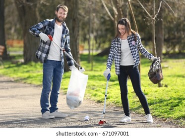 Young volunteers picking up litter in park