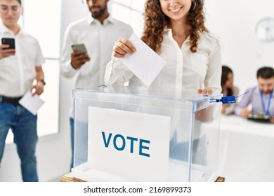 Young Voter Woman Smiling Happy Putting Vote In Voting Box At Electoral Center.