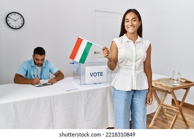 Young Voter Woman Smiling Happy Holding Hungary Flag At Electoral College.