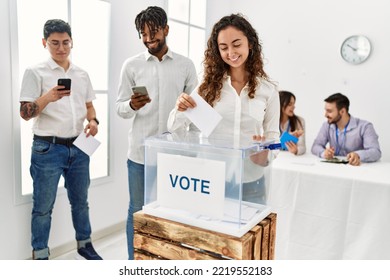 Young Voter Woman Smiling Happy Putting Vote In Voting Box At Electoral Center.