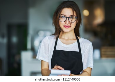 young waitress ready to take order on notepad in restauran - Shutterstock ID 1112449508
