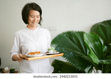 Young waitress serving scone and coffee at cafe - Powered by Shutterstock