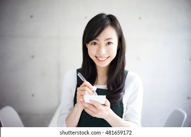 Young waitress woman taking an order.