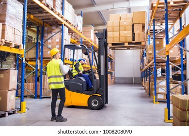 Young warehouse workers working together. - Powered by Shutterstock