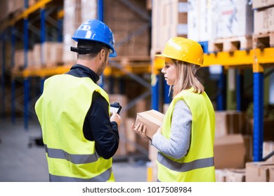 Young Warehouse Workers Working Together.