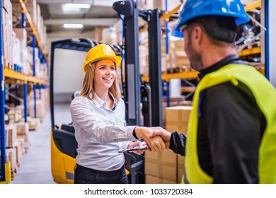 Young Warehouse Workers Working Together.