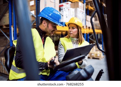 Young Warehouse Workers Working Together.