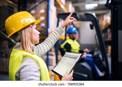 Young Warehouse Workers Working Together.