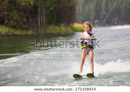 Young Waterskier water skiing on a beautiful scenic lake 
