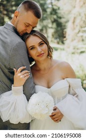 Young Wedding Couple Having Photoshoot In Forest