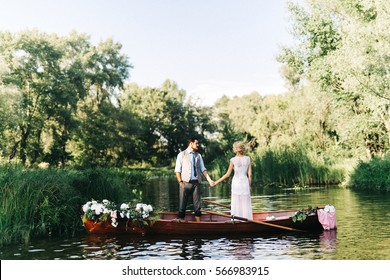 Young wedding couple posing on the boat