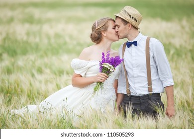 Young Wedding Couple Walking On Field.