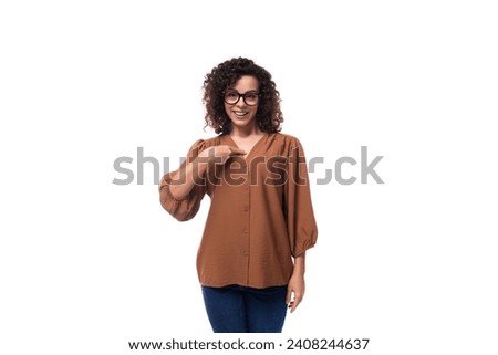 young well-groomed caucasian woman with curly black hair is dressed in a brown blouse