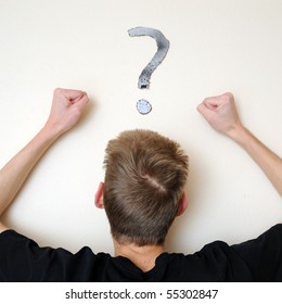 Young white Caucasian male adult staring forward, confused, with a question mark above his head on the wall. Focus point is on the person's head.