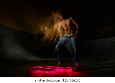 A Young White Caucasian Skateboarder Doing An Ollie Jump At Night