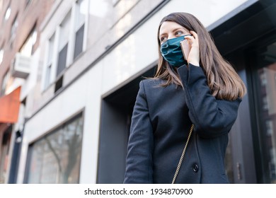 Young white fashionable girl using phone wearing stylish silk face mask, black blazer. Fashion blogger, business woman, busy city life concept - Powered by Shutterstock