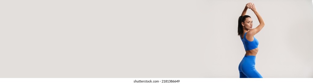 Young white fitness woman wearing sportswear standing over white wall background side view - Powered by Shutterstock