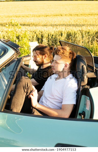 Young white models\
men sitting in the car