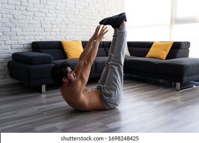 Young White Muscular Man Doing Abs Workout At Home