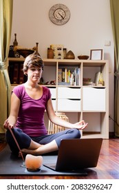 Young White Woman Doing Online Meditation Class At Home With Her Computer.