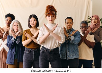 Young white woman gesturing Break The Bias in support of International Women's Day with female friends