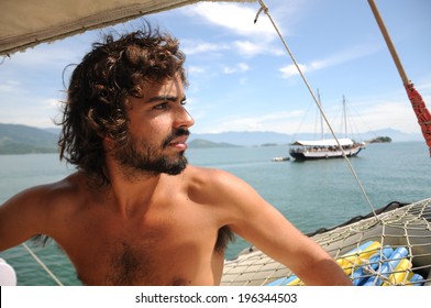 Young Wild Male Sailing through Paraty Islands. Rio do Janeiro. Brazil.  Sao Paulo, South America.
