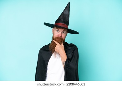 Young Wizard In Halloween Isolated On Blue Background Thinking