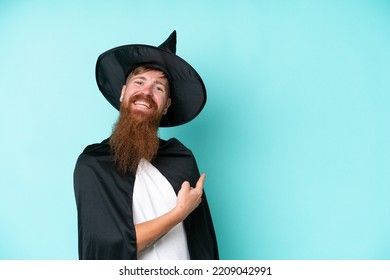 Young Wizard In Halloween Isolated On Blue Background Pointing Back