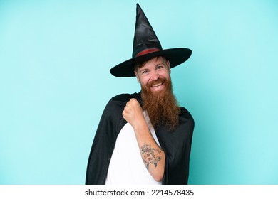 Young Wizard In Halloween Isolated On Blue Background Celebrating A Victory