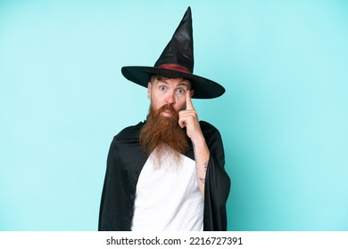 Young Wizard In Halloween Isolated On Blue Background Thinking An Idea