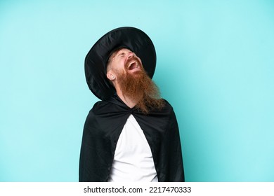 Young Wizard In Halloween Isolated On Blue Background Laughing