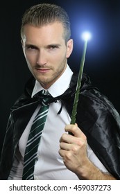 Young Wizard Holding A Magic Wand