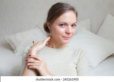 Young Woman 20-25 Years Old At Home Touching Her Neck In Relax Mood