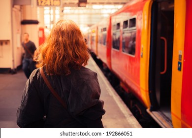 A Young Woman Is About To Board A Train