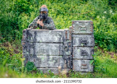 Young Woman In Action While Playing Paintball