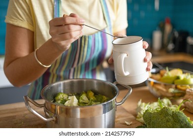 Young Woman Adding Salt To Lunch