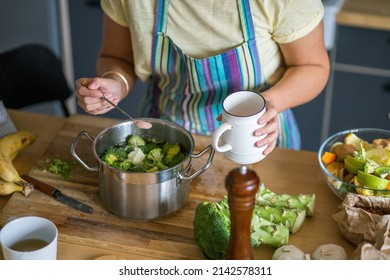 Young Woman Adding Salt To Lunch