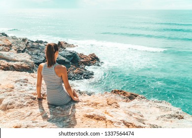 Young Woman Admiring Beautiful Landscape Of Cliffs And Ocean In Algarve, Portugal - Powered by Shutterstock