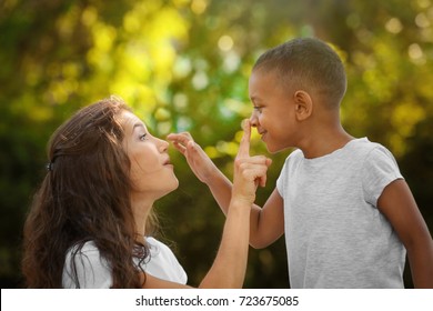 Young woman with adopted African American boy outdoors
