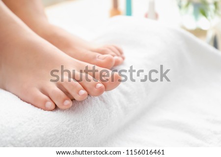 Young woman after getting professional pedicure in beauty salon, closeup