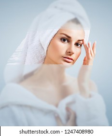 Young Woman After Shower Near Foggy Mirror.