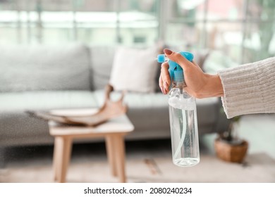 Young Woman With Air Freshener At Home