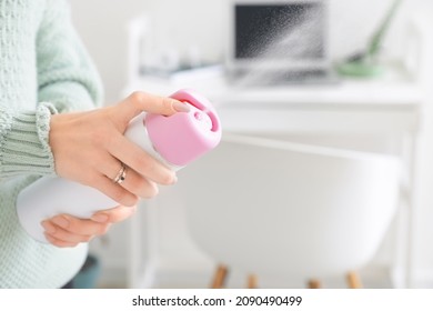 Young Woman With Air Freshener At Home