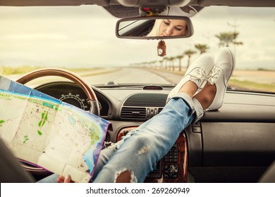 Young woman alone car traveler with map 