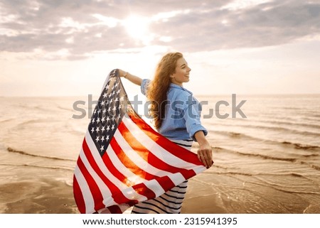 Young woman with  American flag on the beach. Patriotic holiday. USA celebrate 4th of July. Independence Day concept
