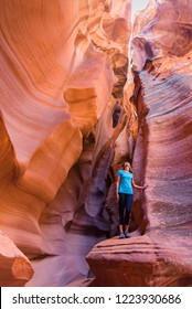 Young Woman In Antelope Canyon In Arizona. Tourist In Antelope Canyon. Adventure And Hiking Concept.