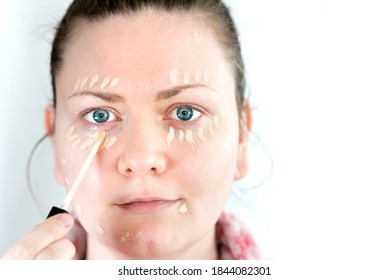 Young Woman Applies Concealer Makeup - Front