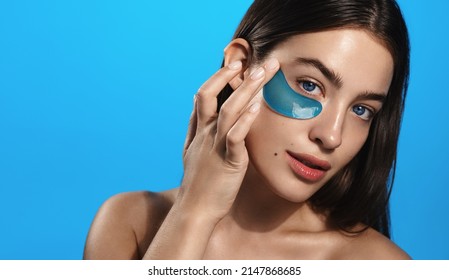 Young Woman Applies Eye Pads, Collagen And Hyaluronic Acid Eye Patches For Skin Care